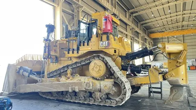 Dozer in a workshop with suppression cylinders mounted on the deck